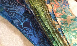 I picked up a couple of these Jelly Rolls at the Labor Day Sale and then did the math on downscaling some star blocks to fit the roll cuts