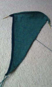 Right side up, front bottom edge of the sweater