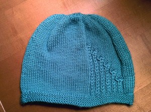 Fresh off the needles, one hat with flowers